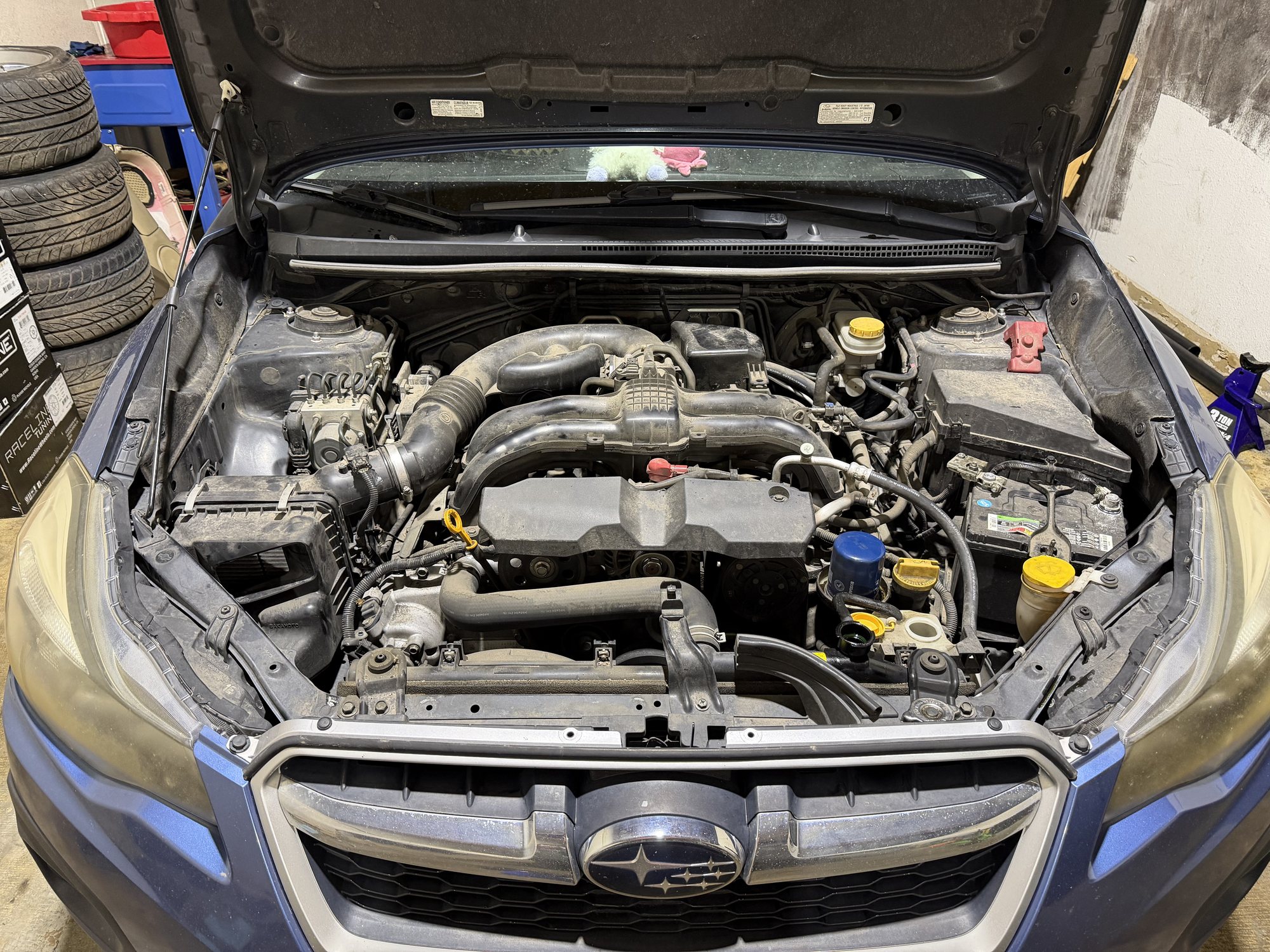 A Subaru in for service at Springs Auto Repair, hood up