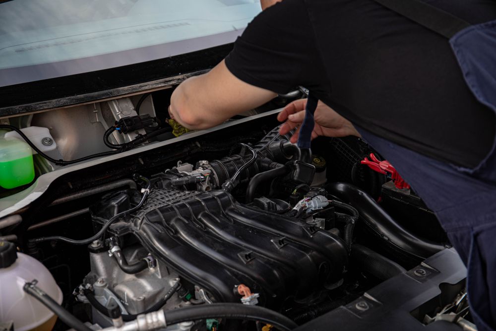 Mechanic's hands working on a car engine