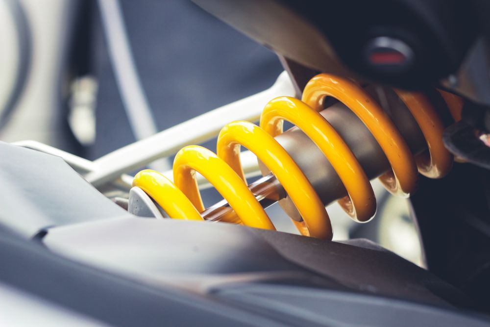 Close-up of a yellow coil spring