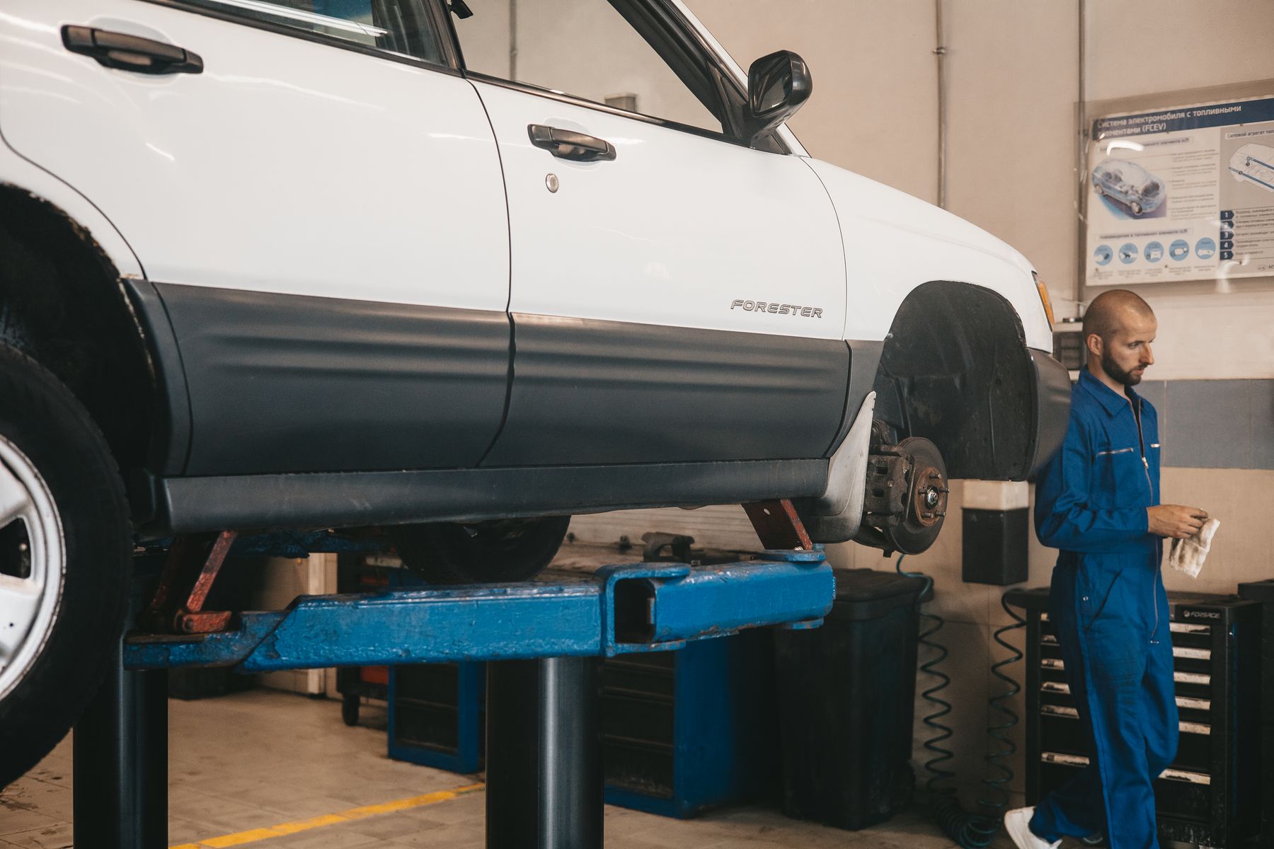 A car raised on a lift in an auto repair shop